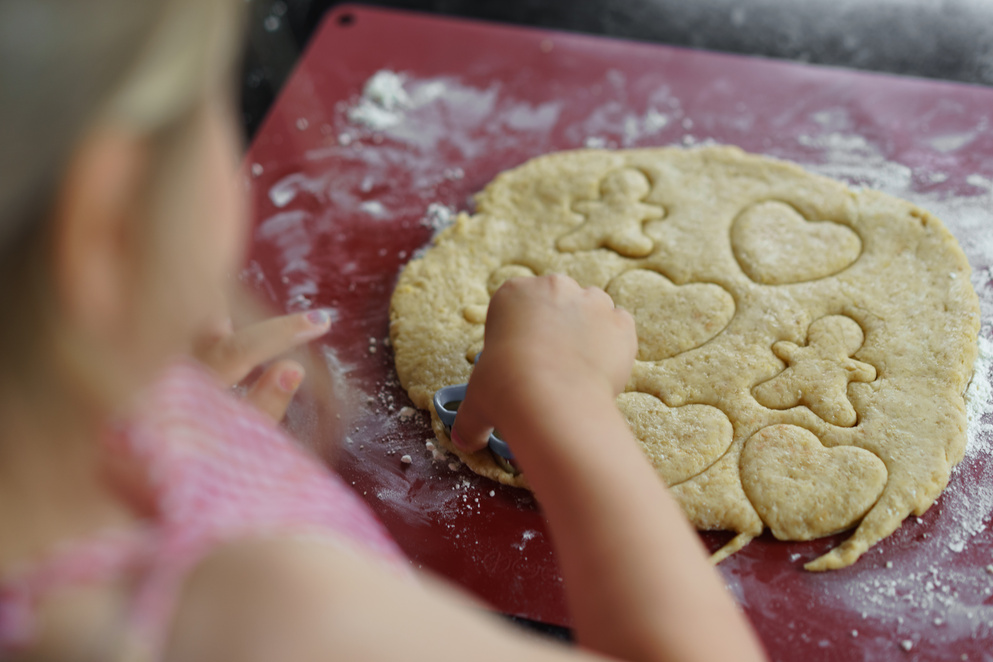 Child cooking cookies.